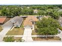 Up high aerial view showing the home and a well-maintained lawn at 1654 Portsmouth Lake Dr, Brandon, FL 33511