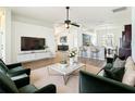 Open-concept living area with modern furniture, a ceiling fan, and lots of natural light at 19910 Wyndmill Cir, Odessa, FL 33556
