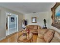 Elegant living room featuring hardwood floors, classic furniture, decorative wall art, and a view into the foyer at 2219 Summit View Dr, Valrico, FL 33596