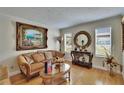 Elegant living room featuring hardwood floors, classic furniture, decorative wall art, and natural light from large windows at 2219 Summit View Dr, Valrico, FL 33596