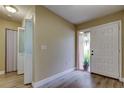 Bright entryway with a front door with glass and sidelights, light wood floors, and large coat closet at 2913 Fig Ct, Palm Harbor, FL 34684