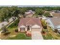 An aerial shot showcasing the charming single-Gathering home in a well-established neighborhood and manicured front yard at 29713 Bright Ray Pl, Wesley Chapel, FL 33543