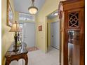 Bright foyer with tile flooring, elegant lighting, and tasteful decor that welcomes you into the home at 29713 Bright Ray Pl, Wesley Chapel, FL 33543