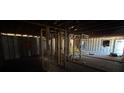 A look at the interior of a home which has exposed studs and visible ceiling rafters at 3308 E Frierson Ave, Tampa, FL 33610
