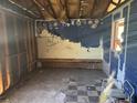 Run down room with painted wall, broken floor, and sticker-covered wall at 3308 E Frierson Ave, Tampa, FL 33610