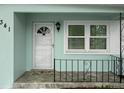 Inviting front porch with decorative railing, offering a warm welcome with its charming details and well-kept appearance at 341 Wertz Dr, Largo, FL 33771