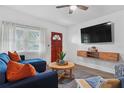 Comfortable living area with a large TV, featuring a cozy seating arrangement, and modern entertainment setup for relaxation at 341 Wertz Dr, Largo, FL 33771