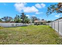 Expansive backyard enclosed by a white fence, offering ample space for recreation and relaxation at 3613 21St S Ave, St Petersburg, FL 33711