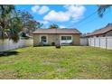 Spacious backyard featuring a well-maintained lawn and a white fence, perfect for outdoor activities at 3613 21St S Ave, St Petersburg, FL 33711