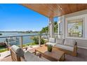 Covered patio with comfortable seating and a beautiful view of the water and waterfront homes at 443 18Th Ave, Indian Rocks Beach, FL 33785