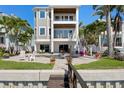 Spacious home with a backyard pool and patio overlooking a scenic waterfront view at 443 18Th Ave, Indian Rocks Beach, FL 33785