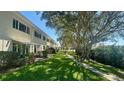 Backyard view of property with well-maintained lawn and walking path at 4560 Overlook Ne Dr # 168, St Petersburg, FL 33703