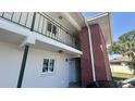Exterior view of a two-story building with a brick facade and a metal balcony railing at 4560 Overlook Ne Dr # 168, St Petersburg, FL 33703