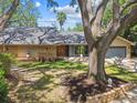 Charming single-Gathering home with a well-maintained lawn and a two-car garage at 48 Bishop Creek Dr, Safety Harbor, FL 34695