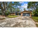 Charming single-Gathering home with a well-maintained lawn and a two-car garage at 48 Bishop Creek Dr, Safety Harbor, FL 34695