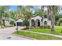 Lovely single-story home with a manicured lawn, brick driveway, and an arched front porch at 5109 Hartwell Loop, Land O Lakes, FL 34638