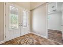 Bright foyer featuring decorative tile flooring and glass paneled double doors at 5117 Longspur Ct, Lithia, FL 33547