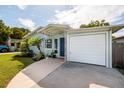 The exterior view captures a well-maintained house with an attached garage at 5527 Kelly N Dr, St Petersburg, FL 33703