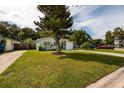 Beautiful exterior view of a house featuring a lovely yard and lush greenery at 5527 Kelly N Dr, St Petersburg, FL 33703