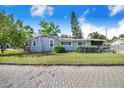 Cozy single-Gathering home with a fenced yard, a chimney, and mature landscaping at 6704 N Branch Ave, Tampa, FL 33604