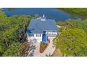 Aerial view showcases this waterfront property with its well-maintained landscape and coastal charm at 6805 Arroyo Dr, New Port Richey, FL 34652