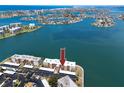 Aerial view of condo building with water views and surrounding neighborhood at 7910 Sun Island S Dr # 404, South Pasadena, FL 33707