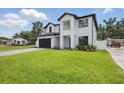 Contemporary home with lush green lawn and minimalist landscaping at 816 W Orient St, Tampa, FL 33603