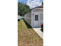 Side view of the home's exterior, showing the siding and entrance door at 8207 Volusia Pl, Tampa, FL 33637