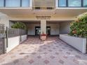 Sailmaster condo entrance with patterned brick, lush plants, and secure access at 830 S Gulfview Blvd # 102, Clearwater Beach, FL 33767