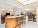 Open kitchen featuring a breakfast bar with seating and views of the living and dining areas at 830 S Gulfview Blvd # 102, Clearwater Beach, FL 33767