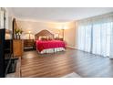 Spacious main bedroom with wood flooring, slider to balcony, and a light and airy atmosphere at 830 S Gulfview Blvd # 102, Clearwater Beach, FL 33767