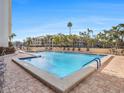 Inviting outdoor pool surrounded by lush landscaping and comfortable seating at 830 S Gulfview Blvd # 102, Clearwater Beach, FL 33767