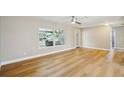 Bright, open living room features light wood floors, large window, and ceiling fan at 8417 Bay Pointe Dr, Tampa, FL 33615
