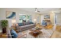 Bright living room featuring hardwood floors, recessed lighting, and a large window showcasing the neighborhood at 8417 Bay Pointe Dr, Tampa, FL 33615