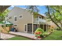 Two-story townhouse featuring a screened porch and white balcony at 9050 Lake Place Ln, Tampa, FL 33634
