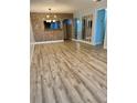 Open living room with new flooring, brick accents, and ample natural light at 1020 85Th N Ave # 223, St Petersburg, FL 33702