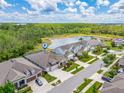 Aerial view of a residential area with a lake and surrounding greenery at 16712 Courtyard Loop, Land O Lakes, FL 34638