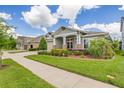 Charming single-Gathering home with a well-manicured lawn and mature landscaping at 16712 Courtyard Loop, Land O Lakes, FL 34638