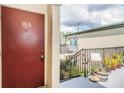 Inviting condo entrance with a front door, stairs, plants, and building exterior, creating a warm welcome at 1799 N Highland Ave # 106, Clearwater, FL 33755