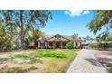 Attractive home featuring a well-manicured lawn and a paved driveway at 2621 Stearns Rd, Valrico, FL 33596