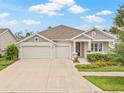 Beautiful one-story home with a convenient three-car garage and manicured front yard, providing great curb appeal at 4166 Epic Cv, Land O Lakes, FL 34638