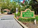 A welcoming entrance to Placido Bayou, a gated community with lush landscaping and a security guardhouse at 5001 Queen Palm Ne Ter, St Petersburg, FL 33703