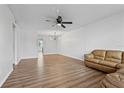 Spacious living room with hardwood floors and modern ceiling fan at 5095 Bay Ne St # 210, St Petersburg, FL 33703