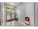 Bright entryway with a decorative glass front door, tile flooring, and a coat closet at 534 Berkley Ave, Tarpon Springs, FL 34689