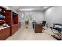 Bright office with neutral walls, tile floor, built in shelves and a window at 534 Berkley Ave, Tarpon Springs, FL 34689