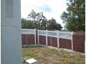 View of the property's backyard, featuring a brick and lattice fence at 5434 Fairfield S Ave # 1, Gulfport, FL 33707