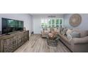 Comfortable living room boasts stylish furniture, hardwood floors, and abundant natural light at 5694 40Th N Ter # 423, Kenneth City, FL 33709