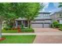Beautiful two-story home featuring a brick driveway, a spacious two-car garage, and a lush landscaped yard at 5724 Shell Ridge Dr, Lithia, FL 33547