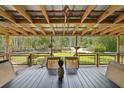 Spacious covered deck with dining table overlooking peaceful wooded backyard at 5817 Myrtle Ln, Tampa, FL 33625