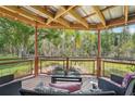 Relaxing outdoor seating area with comfortable chairs overlooking a tranquil pond at 5817 Myrtle Ln, Tampa, FL 33625